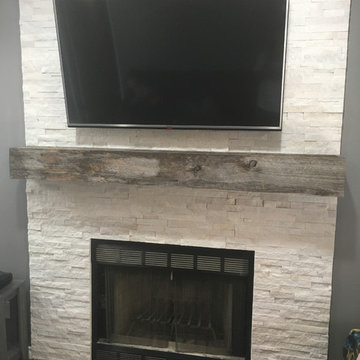 Stacked stone fireplace with reclaimed wood mantle