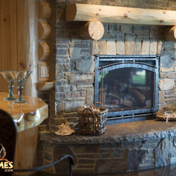 Stone fireplace in a log home model Lakehouse 4166AL by Golden Eagle