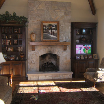 Stone fireplace with cabinets and beams