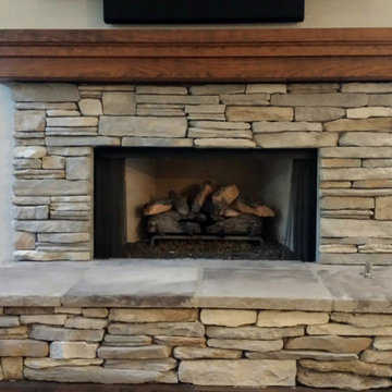 Stone Surrounded Fireplace with Cherry Mantle Beam