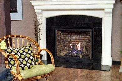 Inspiration for a mid-sized carpeted family room remodel in Boston with beige walls, a standard fireplace and a metal fireplace