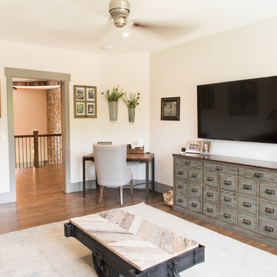 Inspiration for a mid-sized rustic enclosed dark wood floor and brown floor family room remodel in Charleston with beige walls, no fireplace and a wall-mounted tv