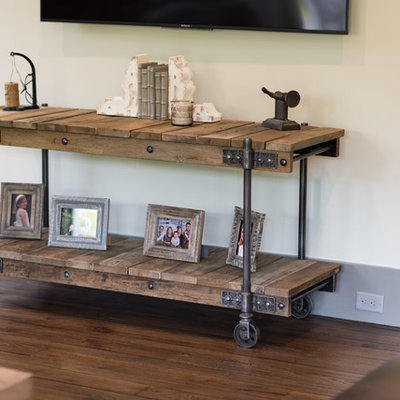 Inspiration for a large rustic open concept dark wood floor and brown floor family room remodel in Charleston with beige walls, a standard fireplace, a stone fireplace and a wall-mounted tv