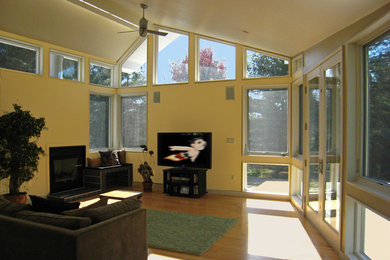 Example of a mid-sized transitional open concept medium tone wood floor family room design in Boston with beige walls and no fireplace