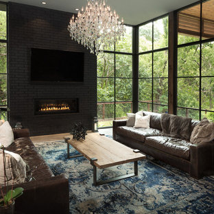 Large trendy open concept concrete floor family room photo in Dallas with gray walls, a ribbon fireplace, a brick fireplace and a wall-mounted tv