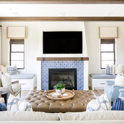 Beach style medium tone wood floor family room photo in San Diego with gray walls, a standard fireplace, a tile fireplace and a wall-mounted tv