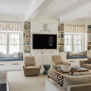 This is an example of a large transitional open concept family room in Boston with a library, a built-in media wall, beige walls, light hardwood floors, no fireplace and beige floor.