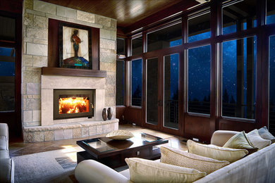 Example of a mid-sized classic open concept travertine floor and beige floor family room library design in Denver with beige walls, a standard fireplace and a stone fireplace