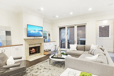 Example of a mid-sized classic open concept dark wood floor and brown floor family room design in Chicago with white walls, a standard fireplace, a stone fireplace and a wall-mounted tv