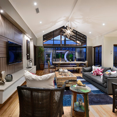 Inspiration for a large contemporary open concept medium tone wood floor family room remodel in Perth with beige walls, no fireplace and a wall-mounted tv