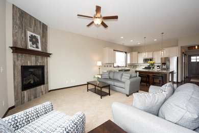 Example of a large transitional open concept carpeted family room design in Minneapolis with beige walls, a standard fireplace and a tile fireplace