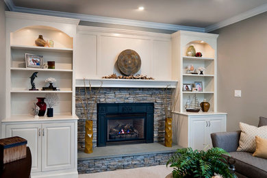 Example of a mid-sized classic enclosed carpeted family room design in Philadelphia with white walls, a standard fireplace, a stone fireplace and a wall-mounted tv