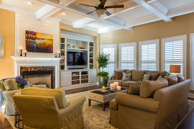 Large transitional open concept medium tone wood floor family room photo in Raleigh with beige walls, a standard fireplace, a tile fireplace and a media wall