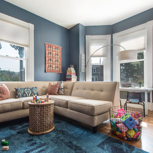 Example of a small transitional medium tone wood floor and beige floor family room design in Boston with blue walls