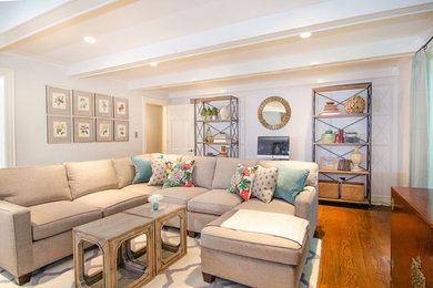 Transitional medium tone wood floor family room photo in Wilmington with gray walls, a standard fireplace, a stone fireplace and a wall-mounted tv