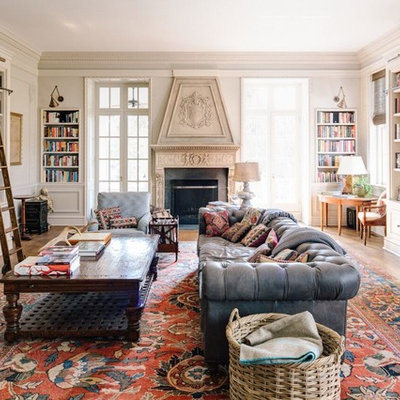 Family room library - huge transitional open concept medium tone wood floor family room library idea in Other with a standard fireplace, a tv stand, gray walls and a stone fireplace