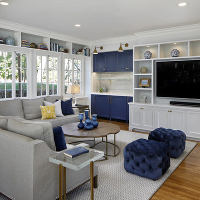 Example of a transitional medium tone wood floor and brown floor family room design in San Francisco with white walls and a wall-mounted tv