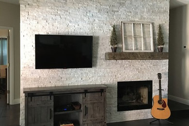 Example of a large transitional open concept dark wood floor and brown floor family room design in Miami with a bar, white walls, a standard fireplace, a stone fireplace and a wall-mounted tv