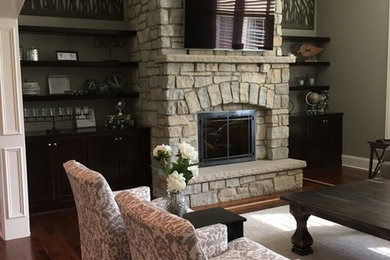 Large transitional enclosed dark wood floor family room photo in Chicago with green walls, a standard fireplace, a brick fireplace and a wall-mounted tv