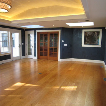 Tray ceiling with LED cove lighting, leather finish walls, cherry doors & floor