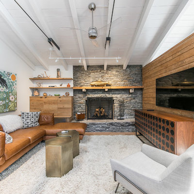 Inspiration for a rustic family room remodel in Other with white walls, a standard fireplace, a stone fireplace and a wall-mounted tv