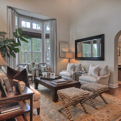 Family room - traditional enclosed medium tone wood floor family room idea in Orange County with gray walls