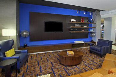 Large minimalist open concept carpeted family room photo in Houston with a media wall and multicolored walls