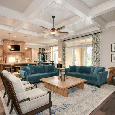 Large tuscan open concept brown floor and dark wood floor family room photo in Sacramento with gray walls