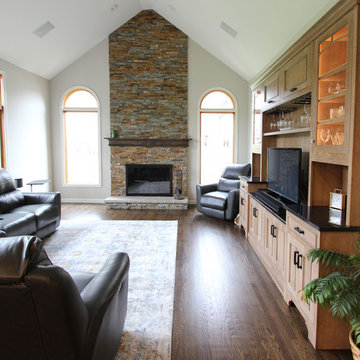 Two Toned Kitchen with White Island and Great Room Stacked Stone Fireplace