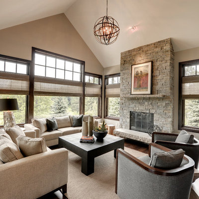 Family room - transitional dark wood floor family room idea in Minneapolis with beige walls, a standard fireplace and a stone fireplace
