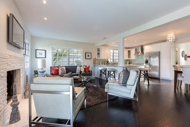 Mid-sized transitional open concept dark wood floor family room photo in Los Angeles with white walls, a standard fireplace, a stone fireplace and a wall-mounted tv