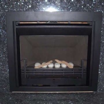 Valor G3 Gas Insert with Black Marble surround and hearth.