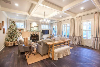 Large transitional open concept dark wood floor family room photo in Other with gray walls, a standard fireplace, a wood fireplace surround and a media wall