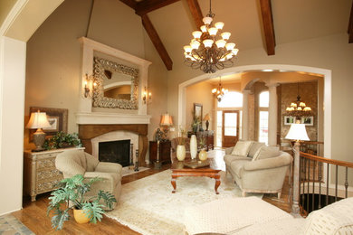 Example of a large classic open concept light wood floor family room design in Kansas City with beige walls, a standard fireplace and a stone fireplace