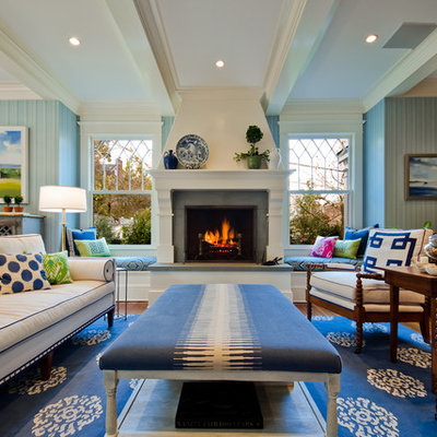 Elegant family room photo in DC Metro with blue walls, a standard fireplace and a wall-mounted tv