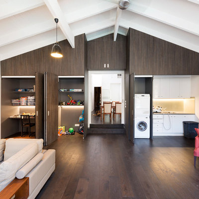 Example of a trendy open concept dark wood floor family room design in Melbourne with white walls