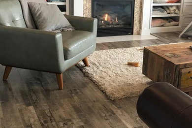 Example of a mid-sized trendy open concept laminate floor and brown floor family room design in Minneapolis