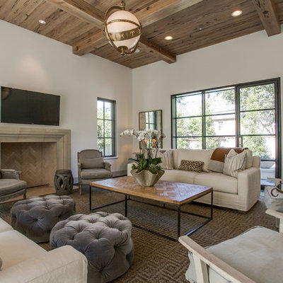 Example of a transitional family room design in Dallas with beige walls, a standard fireplace, a stone fireplace and a wall-mounted tv