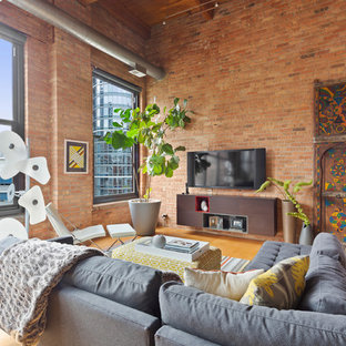 Inspiration for an industrial open concept light wood floor family room remodel in Chicago with red walls, no fireplace and a wall-mounted tv