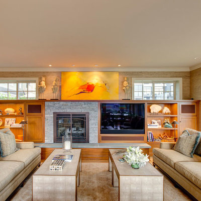 Elegant family room photo in Portland with beige walls, a standard fireplace, a stone fireplace and a media wall