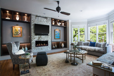 Transitional dark wood floor and brown floor family room photo in Austin with gray walls, a ribbon fireplace and a wall-mounted tv