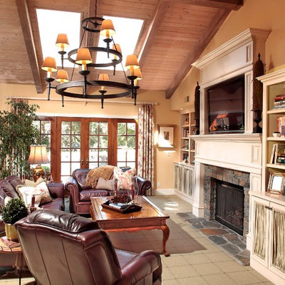 Family room - eclectic family room idea in Los Angeles with a stone fireplace
