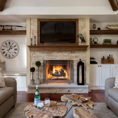 Mid-sized mountain style open concept medium tone wood floor and brown floor family room photo in Chicago with beige walls, a standard fireplace, a stone fireplace and a wall-mounted tv