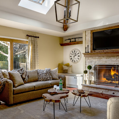 Inspiration for a mid-sized rustic family room remodel in Chicago with beige walls, a standard fireplace, a stone fireplace and a wall-mounted tv