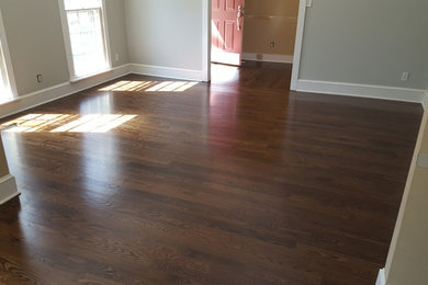 Photo of a medium sized modern enclosed games room in Charlotte with grey walls, dark hardwood flooring, no fireplace, no tv and brown floors.