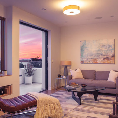 Large trendy enclosed medium tone wood floor family room library photo in Los Angeles with white walls and a wall-mounted tv