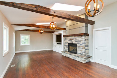 Family room - contemporary brown floor family room idea in Toronto with beige walls and a brick fireplace