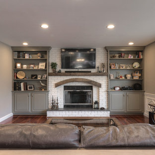 Mid-sized elegant open concept dark wood floor family room photo in St Louis with gray walls, a standard fireplace, a brick fireplace and a wall-mounted tv