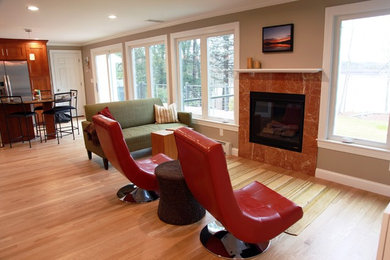 Photo of a medium sized classic open plan games room in Boston with grey walls, light hardwood flooring, a standard fireplace, a tiled fireplace surround and no tv.
