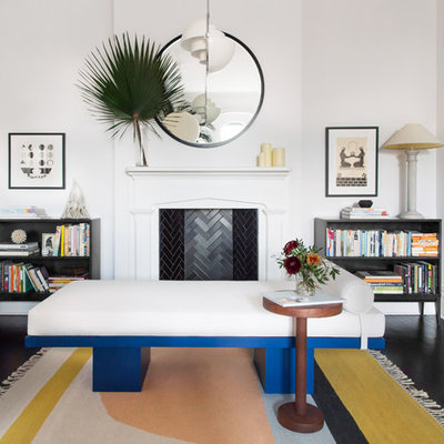 Family room library - victorian enclosed dark wood floor family room library idea in New York with white walls and a standard fireplace